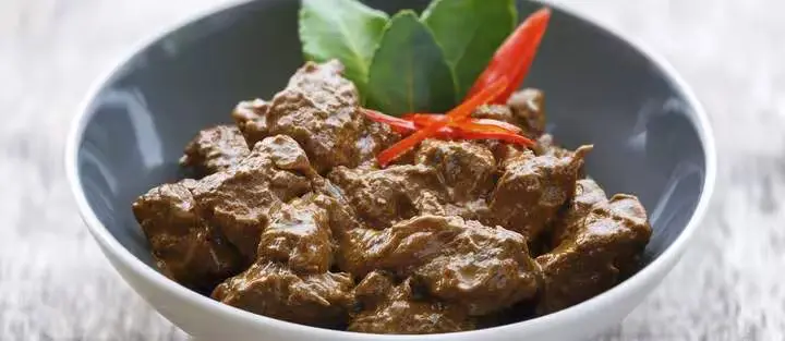 rendang in a bowl with garnish